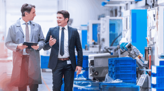 Two-men-touring-a-manufacturing-facility
